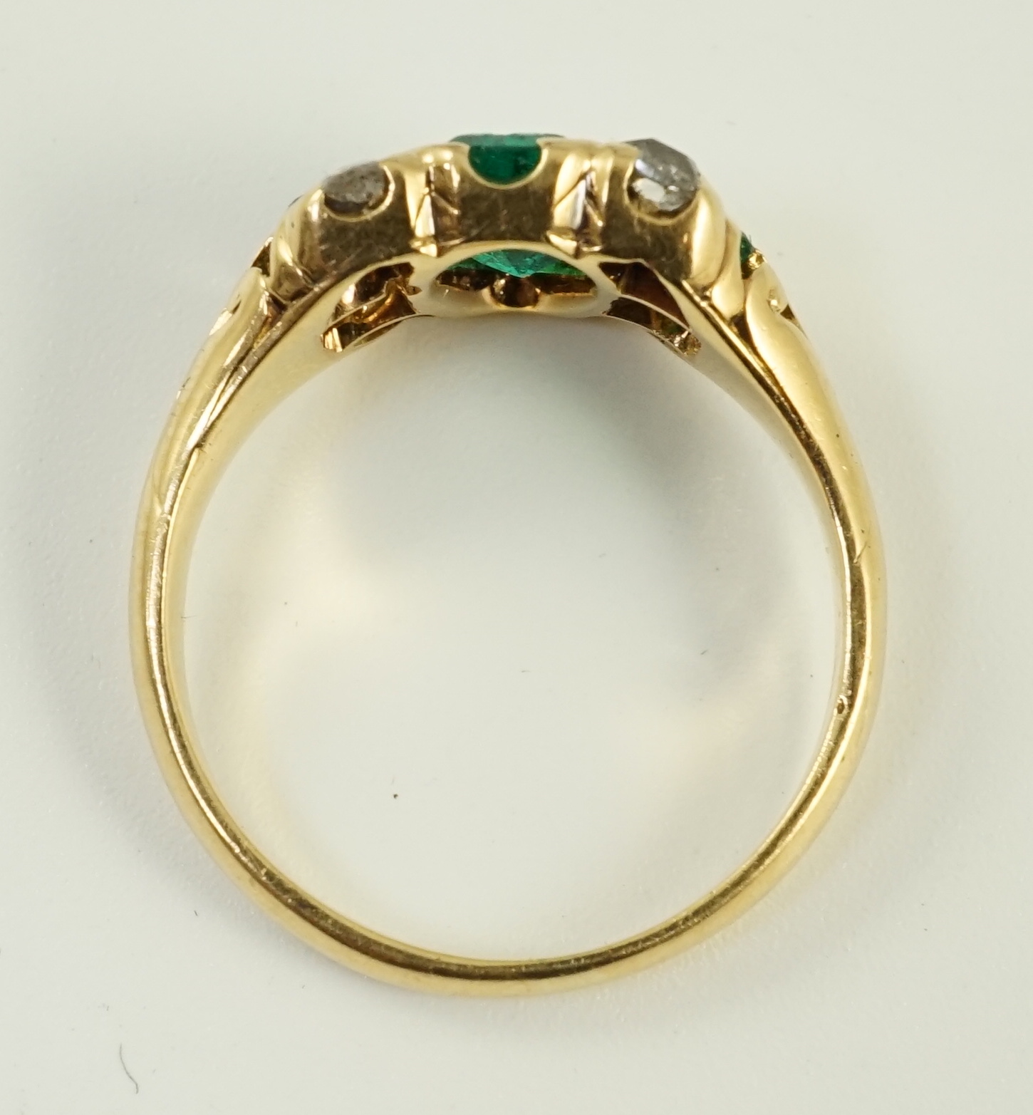 A gold, emerald and diamond cluster ring